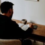 man in black long sleeve shirt sitting at the table