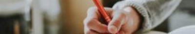 Person Holding Orange Pen